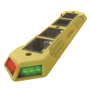 Canalizador Luminus con LEDs solares rojo y verde instalado sobre asfalto oscuro, diseñado para gestionar carriles reversibles en zonas urbanas.